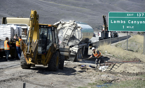 Al Hartmann  |  The Salt Lake Tribune
UDOT crews create berms and absorb crude oil from an oil tanker truck that crashed and spilled oil on westbound I-80 near the Lambs Canyon exit in Parley's Canyon Wednesday April 30, 2014. Some oil seeped into a storm drain before it was contained..