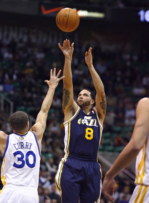 Djamila Grossman  |  The Salt Lake Tribune

The Utah Jazz's Deron Williams (8) shoots past the Golden State Warriors' Stephen Curry (30) during a game in Salt Lake City on Wednesday, Feb.16, 2011. The Jazz lost the game.
