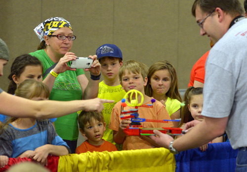 Rick Egan  |  The Salt Lake Tribune

Nathan Rackliffe shows the crowd a LEGO " Orrery"at the South Towne Expo Center, Saturday, May 3, 2014. The BrickSlopes event included LEGO creations from master builders across the U.S. plus a play area for kids with more than 50,000 LEGO bricks.