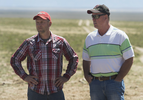 Rick Egan  |  The Salt Lake Tribune

Iron County Commissioner David Miller (left) and Beaver County Commissioner Mark Whitney (right) discuss the problems that come with wild horses grazing on public land northwest of Cedar City, Wednesday, April 23, 2014