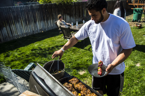 Chris Detrick  |  The Salt Lake Tribune
Former Utah State tight end D.J. Tialavea grills chicken and Shish Kabobs while hanging out with his family at their home in West Jordan Friday May 2, 2014.