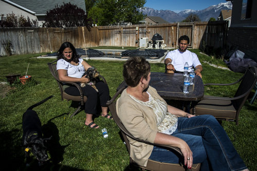 Chris Detrick  |  The Salt Lake Tribune
Former Utah State tight end D.J. Tialavea hangs out with his sister Abigail, mom Tami and dogs Monkey and Mufasa at their home in West Jordan Friday May 2, 2014.
