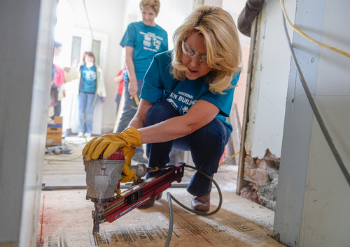Franciso Kjolseth  |  The Salt Lake Tribune
Paige Holland, wife of UVU President Matthew S. Holland takes part in National Women Build Week, as female students, faculty and staff from Utah Valley University and Brigham Young University work together to rebuild a home to help a family in need on Wednesday, May 7, on a Habitat for Humanity home in Utah County. The women along with one of the home owners got dirty and kept busy on the historic 1880's George Taylor, Jr. Home at 187 North 400 West, in Provo.