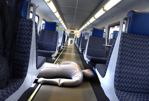 Scott Sommerdorf   |  The Salt Lake Tribune
A blowup doll plays the role of a dead passenger in a FrontRunner train as the Utah Transit Authority held a terrorism bombing drill at the Murray Central Station in conjunction with Intermountain Medical Center, Thursday, May 8, 2014.