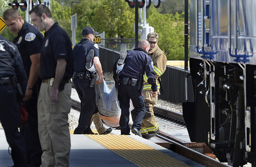 Scott Sommerdorf   |  The Salt Lake Tribune
First responders tote off one of the "wounded" after they were evacuated from the train. UTA held a terrorism bombing drill at the Murray Central Station in conjunction with Intermountain Medical Center, Thursday, May 8, 2014.