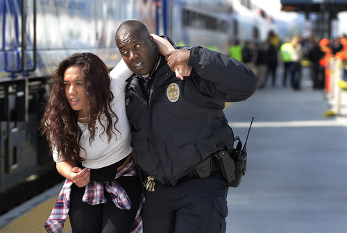 Scott Sommerdorf   |  The Salt Lake Tribune
A policeman carries away a wounded "victim" from the platform as UTA held a terrorism bombing drill at the Murray Central Station in conjunction with Intermountain Medical Center, Thursday, May 8, 2014.