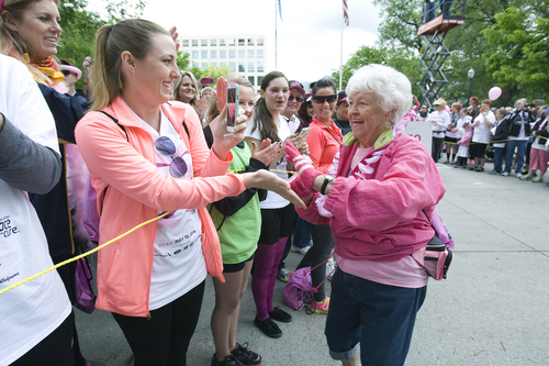 Melissa Majchrzak  |  Special to the Tribune
Beverly Johnson, breast cancer survivor of 15 years, greets people while walking in the Survivor Parade at the Susan G. Komen 18th Annual Race for the Cure at Library Square.
