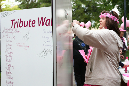 Melissa Majchrzak  |  Special to the Tribune
Carol Neilsen signs the tribute wall at the Susan G. Komen 18th Annual Race for the Cure at Library Square.