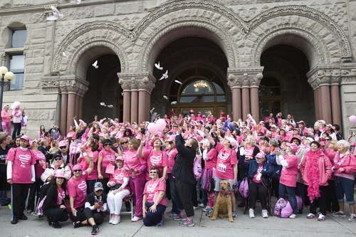 Melissa Majchrzak  |  Special to the Tribune
Pigeons are released behind Breast Cancer Survivors as they pose for a group photo at the Susan G. Komen 18th Annual Race for the Cure at Library Square.