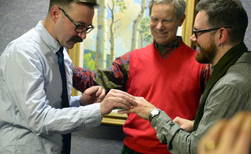 Keith Johnson | The Salt Lake Tribune

Mark Hofeling, left, exchanges rings with new husband Jesse Walker while being married by Salt Lake City mayor Ralph Becker outside the Salt Lake County clerks office, Friday, December 20, 2013. A federal judge in Utah Friday struck down the state's ban on same-sex marriage, saying the law violates the U.S. Constitution's guarantees of equal protection and due process.