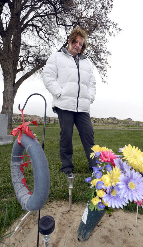 Al Hartmann  |  The Salt Lake Tribune
Midwife Donna Young looks at a grave marker of a stillborn child in Rock Point Cemetery in Maeser just north of Vernal.  She started noticing a higher than usual amounts of stillborn and newborn deaths in the area the past few years.  One corner of the cemetery has several small markers for stillborn and newborn  deaths.    
The TriCounty Health Department is holding a public meeting Wednesday May 7 to investigate the uptick in stillbirths and newborn deaths in the area. Environmentalists believe there's a connection to air pollution from oil and gas drilling.