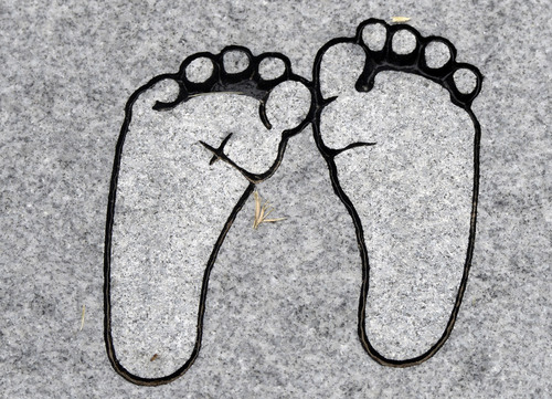 Al Hartmann  |  The Salt Lake Tribune
Etching of baby feet on grave marker of newborn child in Rock Point Cemetery in Maeser just north of Vernal.   One corner of the cemetery has several small markers for stillborn and newborn  deaths.
