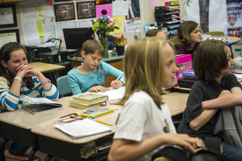 Chris Detrick  |  The Salt Lake Tribune
Megan Hyde, left, and Megan DuVal, center, listen during Mike Sorensen's fifth-grade class at Highland Park Elementary School Thursday May 8, 2014.