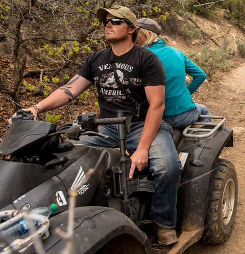 Trent Nelson  |  The Salt Lake Tribune
A rider holds his finger off the trigger of his assault rifle as ATV riders make their way into Recapture Canyon, which has been closed to motorized use since 2007. The protest on Saturday, May 10, 2014 north of Blanding, came after a call-to-action by San Juan County Commissioner Phil Lyman.