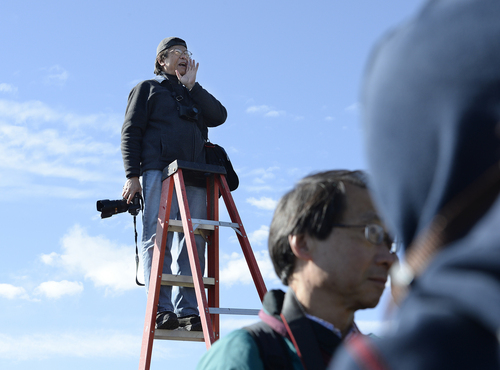 Scott Sommerdorf   |  The Salt Lake Tribune
Photographer Corky Lee shouts to the Chinese community posing near the Golden Spike re-enactment ceremony as he makes a photo of them to honor Chinese immigrants who built the railroad from the west. The community took more than three busloads of people to the Golden Spike National Monument for the 145th commemoration of the completion of the transcontinental railroad, Saturday, May 10, 2014.