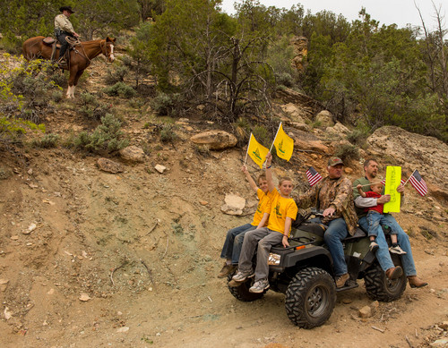 Trent Nelson  |  The Salt Lake Tribune
Under the eyes of a mounted Kane County Sheriff's Deputy, ATV riders make their way into Recapture Canyon, which has been closed to motorized use since 2007. The protest on Saturday, May 10, 2014, north of Blanding, came after a call-to-action by San Juan County Commissioner Phil Lyman.