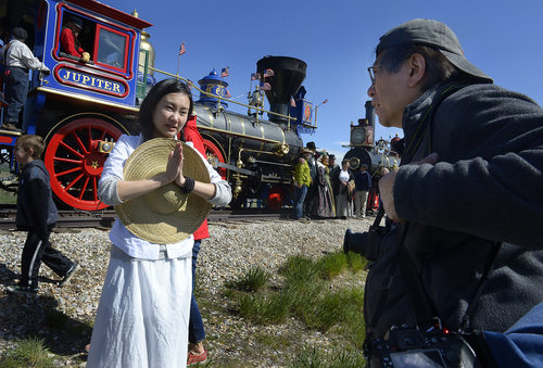 Scott Sommerdorf   |  The Salt Lake Tribune
New York photographer Corky Lee, right, works with dancer Wan Zhao near one of the two locomotives used in the re-enactment of the Golden Spike ceremony, Saturday, May 10, 2014. The Chinese community honored Chinese immigrants who built the railroad from the west by taking more than three busloads of people to the Golden Spike National Monument for the 145th commemoration of the completion of the transcontinental railroad.
