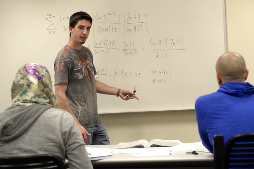 Al Hartmann  |  The Salt Lake Tribune
Recent math and psychology graduate Jammin Gieber tutors students in a calculus problem in the basement of Markosian Library at the Taylorsville/Redwood Road campus of Salt Lake Community college.   After a 2013 report that found 62 percent of Utah high school students aren't ready for college math, the Utah System of Higher Education is issuing new recommendations telling kids who want to go to college to take four years of math rather than the required three.