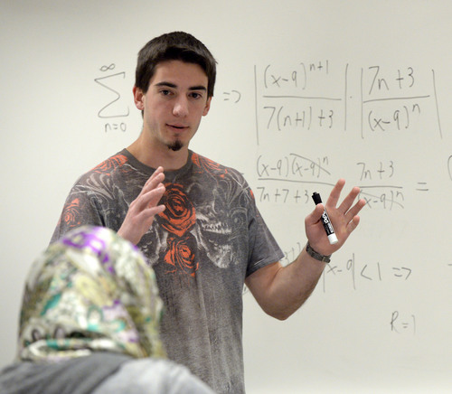 Al Hartmann  |  The Salt Lake Tribune
Recent math and psychology graduate Jammin Gieber tutors students in a calculus problem at Salt Lake Community College's Markosian Library. 
In a more vocal approach than years past, Utah higher education leaders are recommending college-bound high school kids to take four years of math instead of the required three.