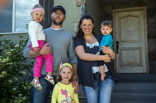 Chris Detrick  |  The Salt Lake Tribune
Donavan and Vanessa Hecker pose for a portrait with their kids, Adlai, 4, Maelle, 2, and Koryn, 11 months, at their home in Magnaon  Thursday, May 8, 2014.