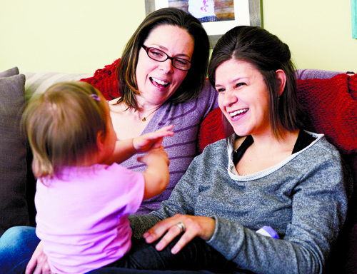 Al Hartmann  |  The Salt Lake Tribune 
Kimberly, left, and Amber Leary play "Itsy-Bitsy Spider" with their 15-month-old daughter on Thursday, February 27, at their home. They are among an unknown number of gay couples in Utah whose efforts to pursue second-parent adoptions have been thwarted by a stay of a court decision overturning the same-sex marriage ban and intervention by the Utah Attorney General's Office.