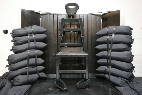 Trent Nelson  |  Tribune file photo

The execution chamber at the Utah State Prison after Ronnie Lee Gardner was executed by firing squad Friday, June 18, 2010. Four bullet holes are visible in the wood panel behind the chair. Gardner was convicted of aggravated murder, a capital felony, in 1985.