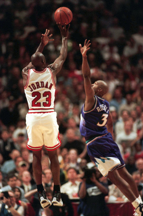 Tribune file photo
IThe Chicago Bulls' Michael Jordan puts up the game-winning shot over Utah Jazz forward Bryon Russell, right, to win Game 1 of the  NBA Finals 84-82 Sunday, June 1, 1997, in Chicago. A year later, Jordan did the same thing against Russell in Game 6 of the '98 Finals, hitting the game-winner at the Delta Center.