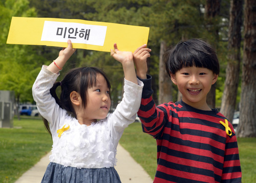 Rick Egan  |  The Salt Lake Tribune

Rosa Chen, 4, and Josh Chen, 6, hold a sign in honor of the victims of the South Korea ferry disaster, during a rally at Liberty Park, Sunday, May 18, 2014.  The rally was held to remember, honor and pray for victims and families of the South Korea ferry disaster that killed more than 300 people, mostly high school students, on April 26. It was organized by Korean ex-patriots living in Utah as part of a 50-state rally organized by Missy USA, a social website catering to Korean and Korean American women in the U.S.