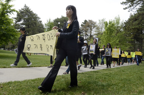Rick Egan  |  The Salt Lake Tribune

Supporters march in honor of the victims of the South Korea ferry disaster, during a rally at Liberty Park, Sunday, May 18, 2014.  The rally was held to remember, honor and pray for victims and families of the South Korea ferry disaster that killed more than 300 people, mostly high school students, on April 26. It was organized by Korean ex-patriots living in Utah as part of a 50-state rally organized by Missy USA, a social website catering to Korean and Korean American women in the U.S.