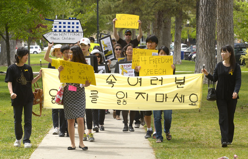 Rick Egan  |  The Salt Lake Tribune

Supporters march in honor of the victims of the South Korea ferry disaster, during a rally at Liberty Park, Sunday, May 18, 2014.  The rally was held to remember, honor and pray for victims and families of the South Korea ferry disaster that killed more than 300 people, mostly high school students, on April 26. It was organized by Korean ex-patriots living in Utah as part of a 50-state rally organized by Missy USA, a social website catering to Korean and Korean American women in the U.S.