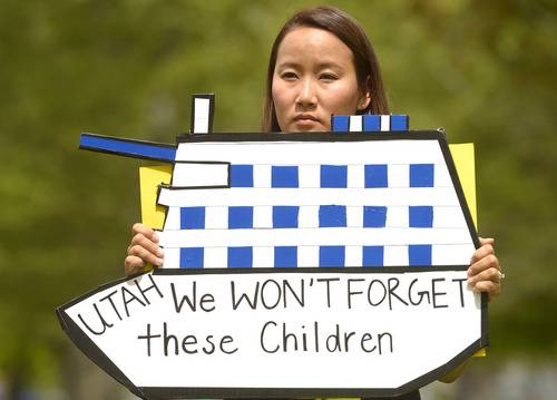 Rick Egan  |  The Salt Lake Tribune

Jieun Rasband holds a sign in honor of the victims of the South Korea ferry disaster, during a rally at Liberty Park, Sunday, May 18, 2014.  The rally was held to remember, honor and pray for victims and families of the South Korea ferry disaster that killed more than 300 people, mostly high school students, on April 26. It was organized by Korean ex-patriots living in Utah as part of a 50-state rally organized by Missy USA, a social website catering to Korean and Korean American women in the U.S.