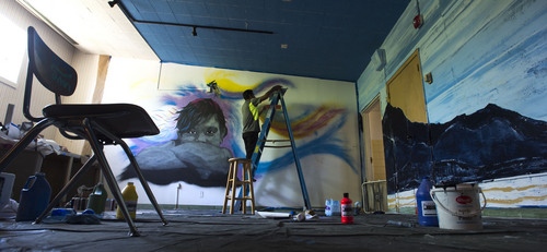 Steve Griffin  |  The Salt Lake Tribune


Artist Jorge Arellano works on a spray paint mural in a class room inside the old Granite High School building in Salt Lake City, Utah Thursday, May 15, 2014.  The old building will house "Dreamathon," an interactive art exhibit that utilizes murals, photography, music, writing and storytelling to empower visitors to discover and live their dreams. Over 150 artisans from the local community have joined together to create a landscape of dreams by transforming the main section of the historic building.