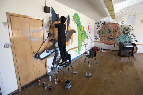Steve Griffin  |  The Salt Lake Tribune


Artist Clay Cavenders paints a mural in a class room inside the old Granite High School building in Salt Lake City, Utah Thursday, May 15, 2014.  The old building will house "Dreamathon," an interactive art exhibit that utilizes murals, photography, music, writing and storytelling to empower visitors to discover and live their dreams. Over 150 artisans from the local community have joined together to create a landscape of dreams by transforming the main section of the historic building.