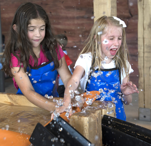 Rick Egan  |  The Salt Lake Tribune

Donnine Benson, and Joplin Cross, 7, Orem, play in the Water Movin' feature in the water works section, at the Museum of Natural Curiosity, at Thanksgiving Point, Saturday, May 17, 2014