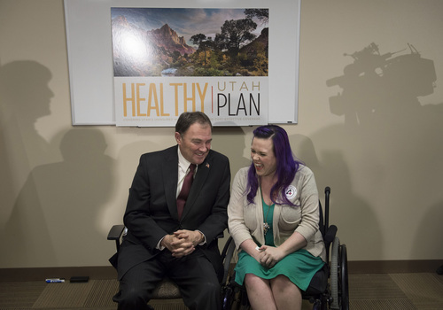 Keith Johnson | The Salt Lake Tribune
Utah Gov. Gary Herbert talks to Stacy Davis-Stanford before having their picture taken together, following a panel discussion on March 6, 2014, at the Fourth Street Clinic in Salt Lake City. Herbert met with patients and families who will benefit most from his proposed alternative to a Medicaid expansion.