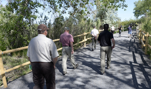 Al Hartmann  |  The Salt lake Tribune 
Box Elder County, state and federal officials walk along the newly contructed nature trail that passes through the restored wetland area at Willard Bay State Park's Eagle Beach Pavillion North Marina Wednesday May 21. The area was closed in Spring 2013 due to a diesel fuel spill from an underground pipeline.  The area has since undergone clean up and improvements including wildlife habitat, restoration of nature trails and new day-use and overflow parking.  The area will officialy open to the public on Saturday.