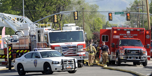 Al Hartmann  |  The Salt Lake Tribune
Firefighters from several departments mop up after a fire at a business at 3345 S. 200 East in South Salt Lake Thursday May 22, 2014