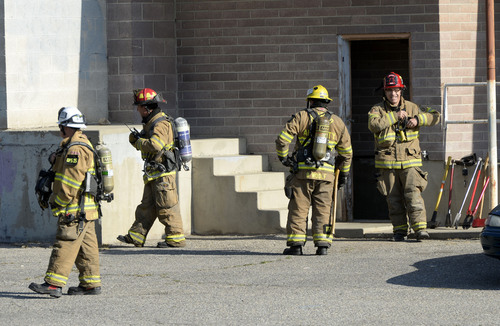 Al Hartmann  |  The Salt Lake Tribune
Firefighters from several departments mop up after a fire at a business at 3345 S. 200 East in South Salt Lake Thursday May 22, 2014