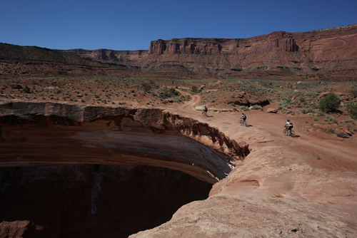 Francisco Kjolseth  |  Tribune file photo
Mountain bikers ride the edge of the White Rim Trail in Canyonlands National Park in May 2013.