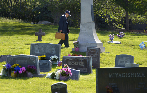 Scott Sommerdorf   |  The Salt Lake Tribune
Reverend Masami Hayashi walks through the Japanese section of Salt Lake City Cemetery after speaking at the Memorial Day service to remember WWII Japanese veterans, Sunday, May 25, 2014.
