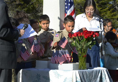 Scott Sommerdorf   |  The Salt Lake Tribune
Boy Scouts place flags as names of Japanese-American veterans are read as members of the Japanese community remember Japanese veterans, Sunday, May 25, 2014.