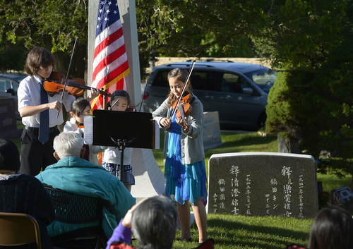 Scott Sommerdorf   |  The Salt Lake Tribune
The Skowronek family of Jacob, Julia, Kaylie, and Allie play as members of the Japanese community gathered at the Japanese section of Salt Lake City Cemetery to remember Japanese veterans, Sunday, May 25, 2014.