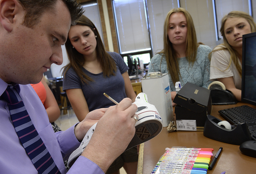 Scott Sommerdorf   |  The Salt Lake Tribune
Students watch as Woods Cross High teacher Shon Feller, left, leads a class about creating a design on a Converse tennis shoe, Thursday, May 15, 2014. Feller works with students to create electronic posters and teach design. Feller is known for encouraging kids to use their mobile devices in class, as well as social networking and teaching kids through technology.