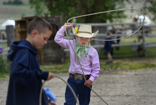 Scott Sommerdorf   |  The Salt Lake Tribune
Toby MacRaywren, 7, takes aim at his friend Dillon Nielson, 8, as they practice roping on each other at the 10th Annual Cowboy Poetry and Western Music Festival at the Fielding Garr Ranch at Antelope Island State Park, Saturday, May 24, 2014.