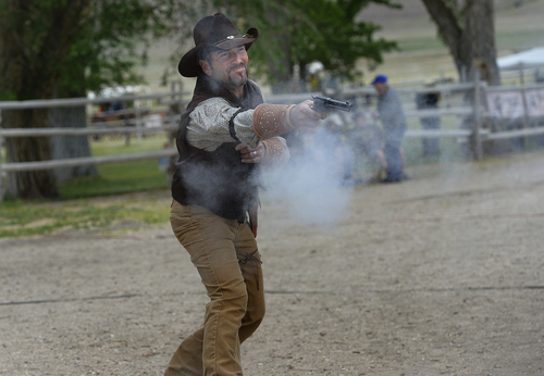 Scott Sommerdorf   |  The Salt Lake Tribune
Bob James of the Weber County Sheriff's Mounted Posse, shoots during a mock gun battle at the 10th Annual Cowboy Poetry and Western Music Festival at the Fielding Garr Ranch at Antelope Island State Park, Saturday, May 24, 2014.