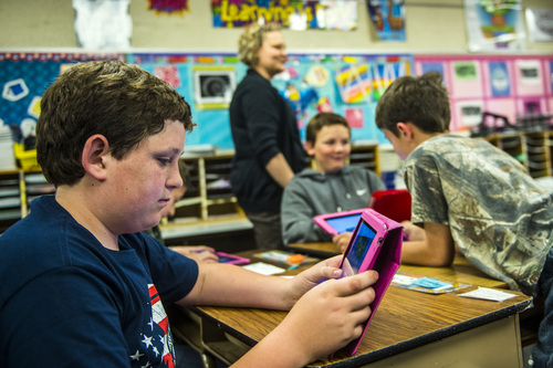 Chris Detrick  |  The Salt Lake Tribune
Sky Lake-Allen, left, Braxton Bates, center, and Tucker York use iPads to help learn about American history during Amber Palmer's class at Bennion Elementary School Tuesday May 6, 2014.