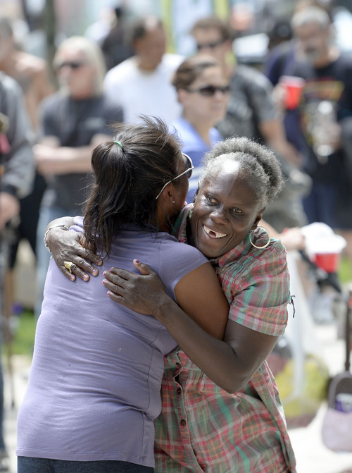 Al Hartmann  |  The Salt Lake Tribune
Women share a hug after dancing to a radio DJ's music as others wait in line to get free Subway sandwiches, fruit, and drinks at Pioneer Park Wednesday May 28.  Subway partnered with the Resuce Mission of Salt Lake for the annual "Day of Giving" with free Subway sandwiches, clothes and giveaways for low income and homeless people.   Subway also presented a $10,000 check to the Rescue Mission of Salt Lake.