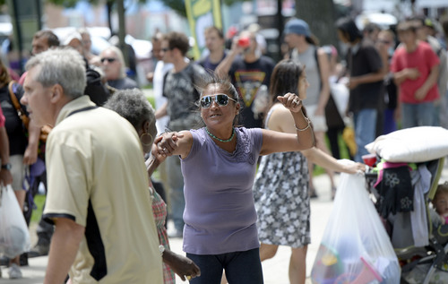 Al Hartmann  |  The Salt Lake Tribune
People dance to a radio dj's music and others wait in line to get free Subway sandwiches, fruit, and drinks at Pioneer Park Wednesday May 28.  Subway partnered with the Resuce Mission of Salt Lake for the annual "Day of Giving" with free Subway sandwiches, clothes and giveaways for low income and homeless people.   Subway also presented a $10,000 check to the Rescue Mission of Salt Lake.