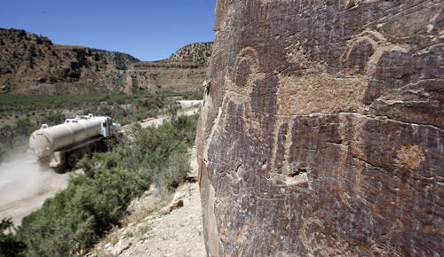 Al Hartmann  |  Tribune file photo
Service vehicles from the nearby gas wells kick up dust in Nine Mile Canyon. The dust is believed to damage the rock art panels. Critics of a proposal to pave the old road say it wouldn't permanently protect the antiquities.