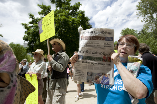 Melissa Majchrzak  |  Special to the Tribune
Gina Fisher holds copies of the Salt Lake Tribune at the "Save the Tribune" rally, held at the City and County building in Salt Lake City on Saturday.